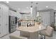 Modern kitchen with white cabinets, stainless steel appliances, and an island at 11111 Callisia Dr, Odessa, FL 33556
