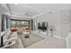 Bright living room featuring a sectional sofa and a large TV at 11111 Callisia Dr, Odessa, FL 33556