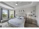 Spacious main bedroom with a large bed, plenty of light and window seating at 11111 Callisia Dr, Odessa, FL 33556