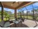 Relaxing screened patio with seating area and view of backyard at 11111 Callisia Dr, Odessa, FL 33556
