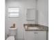 Clean bathroom with granite countertop, white vanity, and toilet at 1318 E Louise Ave, Tampa, FL 33603