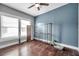 Bright bedroom with hardwood floors and ceiling fan at 1318 E Louise Ave, Tampa, FL 33603