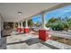 Spacious front porch with stone-tiled floor and view of the street at 1318 E Louise Ave, Tampa, FL 33603