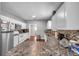 Modern kitchen with white cabinets and granite countertops at 1318 E Louise Ave, Tampa, FL 33603