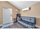 Cozy living area with a sleeper sofa and access to an exterior door at 1318 E Louise Ave, Tampa, FL 33603