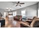 Living room with brown couches and hardwood floors at 1318 E Louise Ave, Tampa, FL 33603