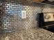 Kitchen backsplash with metallic-look tiles at 17009 Clear Cork Dr, Wimauma, FL 33598