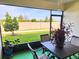Enclosed patio with table and chairs, offering backyard views at 17009 Clear Cork Dr, Wimauma, FL 33598