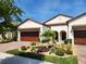 Beautiful two-story home with a landscaped front yard and two-car garage at 17009 Clear Cork Dr, Wimauma, FL 33598