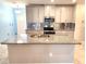Island kitchen with granite countertops and stainless steel appliances at 17009 Clear Cork Dr, Wimauma, FL 33598
