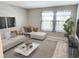 Bright living room featuring a sectional sofa and coffee table at 17009 Clear Cork Dr, Wimauma, FL 33598