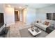 Open living area with a comfortable sofa and access to upper level at 17009 Clear Cork Dr, Wimauma, FL 33598