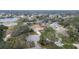 Aerial view showcasing a house nestled in a residential neighborhood near a lake at 1760 Kenesaw Ln, Clearwater, FL 33765