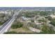 An aerial view showing a house on a large lot near a busy road at 1760 Kenesaw Ln, Clearwater, FL 33765