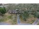 Aerial view of a single-story house with a large yard and trees at 1760 Kenesaw Ln, Clearwater, FL 33765