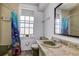 Bathroom with shower/tub combo, tile flooring, and a single sink vanity at 1760 Kenesaw Ln, Clearwater, FL 33765