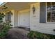 House's entrance with double doors, gray shutters, and exterior lighting at 1760 Kenesaw Ln, Clearwater, FL 33765