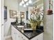 Bathroom with granite countertop and white cabinets at 23 Concord Dr, Dunedin, FL 34698