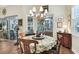 Bright breakfast nook features a round table and chairs, and access to a screened patio at 23 Concord Dr, Dunedin, FL 34698