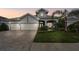 Stunning two-story home with a three-car garage and landscaped yard at 23 Concord Dr, Dunedin, FL 34698