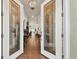 Double front doors open to a hardwood foyer at 23 Concord Dr, Dunedin, FL 34698