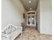 Inviting front porch with a white bench and double doors at 23 Concord Dr, Dunedin, FL 34698