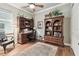 Home office with built-in bookcases and hardwood floors at 23 Concord Dr, Dunedin, FL 34698