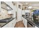 White kitchen with granite countertops and stainless steel appliances at 23 Concord Dr, Dunedin, FL 34698