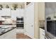 White kitchen with double ovens, granite countertops, and stainless steel appliances at 23 Concord Dr, Dunedin, FL 34698