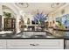 Kitchen island with granite countertop and large sink with a view into Gathering room at 23 Concord Dr, Dunedin, FL 34698