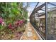 A stone path winds through a lushly landscaped backyard at 23 Concord Dr, Dunedin, FL 34698