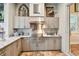 Upscale outdoor kitchen with stainless steel appliances and granite countertops at 23 Concord Dr, Dunedin, FL 34698