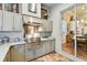 Stainless steel appliances and granite countertops highlight this outdoor kitchen at 23 Concord Dr, Dunedin, FL 34698