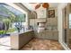 Outdoor kitchen with granite countertops and built-in grill at 23 Concord Dr, Dunedin, FL 34698