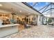 Spacious covered patio with seating area and screened enclosure at 23 Concord Dr, Dunedin, FL 34698