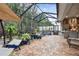 Enjoy this relaxing screened patio with fountain and outdoor kitchen access at 23 Concord Dr, Dunedin, FL 34698