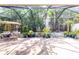 Relaxing screened patio with fountain, seating, and lush landscaping at 23 Concord Dr, Dunedin, FL 34698