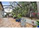 This relaxing screened patio features a seating area and lush landscaping at 23 Concord Dr, Dunedin, FL 34698