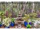 Tiered fountain is the centerpiece of this lush, screened patio garden at 23 Concord Dr, Dunedin, FL 34698