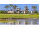 Gated community entrance with palm trees and a pond at 29571 Velletri Ln, Wesley Chapel, FL 33545