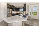 Modern kitchen with dark wood cabinets and a large island with seating at 29571 Velletri Ln, Wesley Chapel, FL 33545