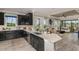 Open-concept kitchen with a large island and views to the living room and backyard at 29571 Velletri Ln, Wesley Chapel, FL 33545
