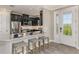 Modern kitchen with dark cabinetry, granite countertops, and stainless steel appliances at 29571 Velletri Ln, Wesley Chapel, FL 33545