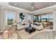 Bright and airy living room, featuring a comfortable seating area with sliding doors leading to a lanai at 29571 Velletri Ln, Wesley Chapel, FL 33545