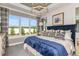 Spacious main bedroom with large windows, a navy bed, and a chandelier at 29571 Velletri Ln, Wesley Chapel, FL 33545