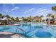 Large resort-style pool with plenty of lounge chairs and shade structures at 29571 Velletri Ln, Wesley Chapel, FL 33545