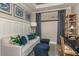 Study or home office with a light gray sofa, navy blue ottomans, and a desk at 29571 Velletri Ln, Wesley Chapel, FL 33545