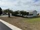 Landscaped manufactured home with a covered patio at 37729 Neukom Ave, Zephyrhills, FL 33541