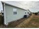 Rear view of the manufactured home with AC unit at 37729 Neukom Ave, Zephyrhills, FL 33541