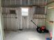 Workshop with shelving and lawnmower at 37729 Neukom Ave, Zephyrhills, FL 33541